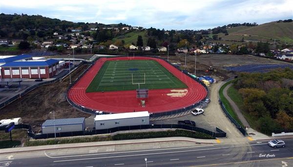 Aerial Shot of the complete jobsite that shows the fieldhouse pad and progress in the top right fields.